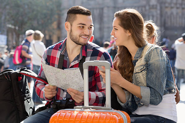 istock Couple with luggage walking 475724352
