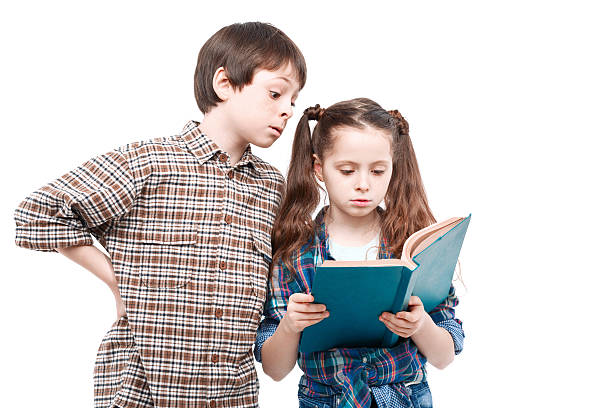 istock Brother and sister posing with a book 475724470