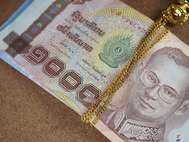 istock Binding Gold Necklace with Thai Banknotes Money 475725658