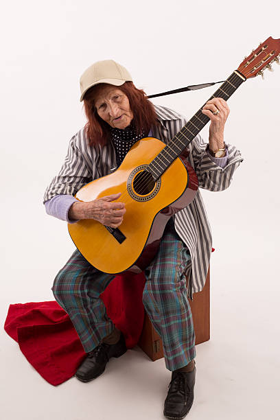 istock Funny elderly lady playing acoustic guitar 475726268