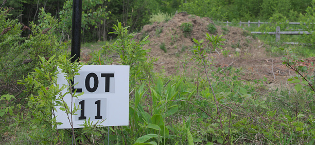 Lot 11 has been abandoned, and all there is to show for it is a sign and a pile of dirt.
