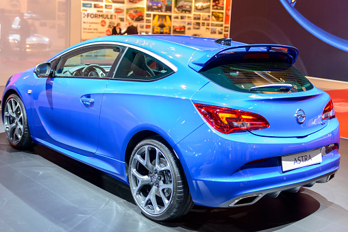 Amsterdam, The Netherlands - April 16, 2015: Opel Astra OPC hatchback car on display during the 2015 Amsterdam motor show. People in the background are looking at the cars.