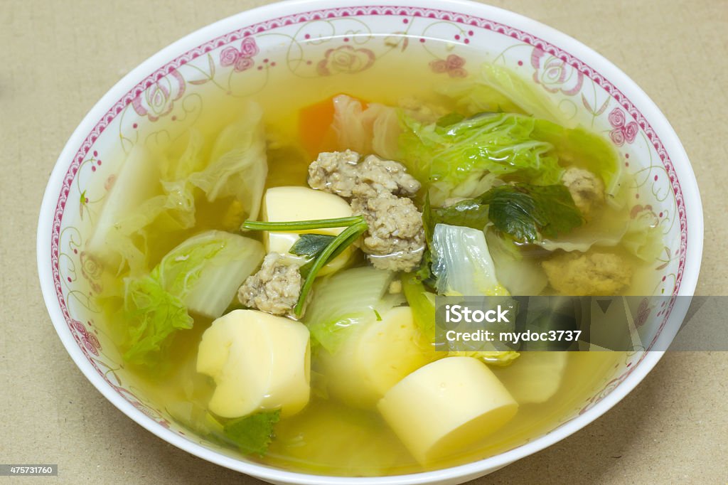 clear soup with bean curd and minced pork in dish clear soup with bean curd and minced pork in dish on cardboard background 2015 Stock Photo