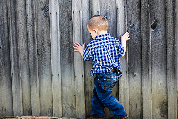 istock Child Walks by Planks on Wood Barn 475731850
