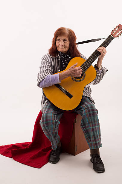 istock Funny elderly lady playing acoustic guitar 475732014