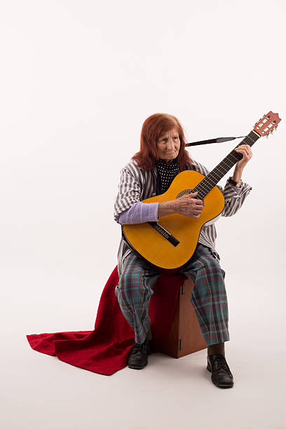 istock Funny elderly lady playing acoustic guitar 475732020