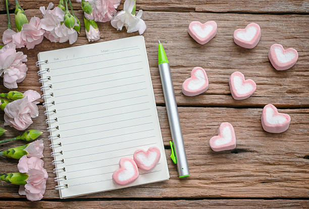 istock Blank notebook with flower on vintage wooden table 475732200