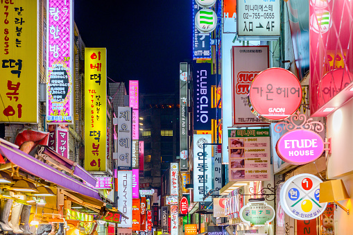 Seoul, South Korea - February 14, 2013: The neon lights of Myeong-Dong at night. The location is the premiere district for shopping in the city.