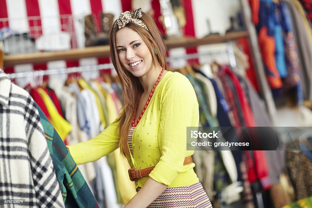 Her favourite fashion store! A hip young woman standing by a clothing rail in a fashion store 20-24 Years Stock Photo