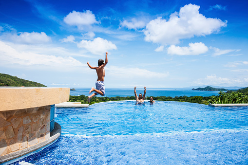 A boy jumps into a pool in Costa Rica.