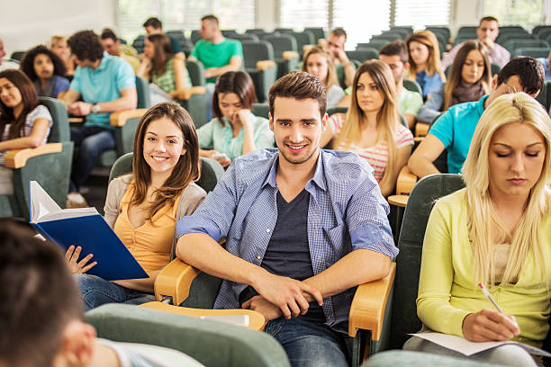 istock Large group of students sitting in lecture hall. 475743802