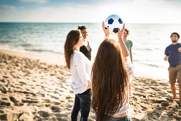 istock friends playing volleyball on the beach 475744770