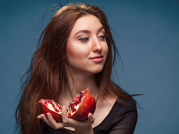 istock Portrait  young girl with pomegranate 475745022