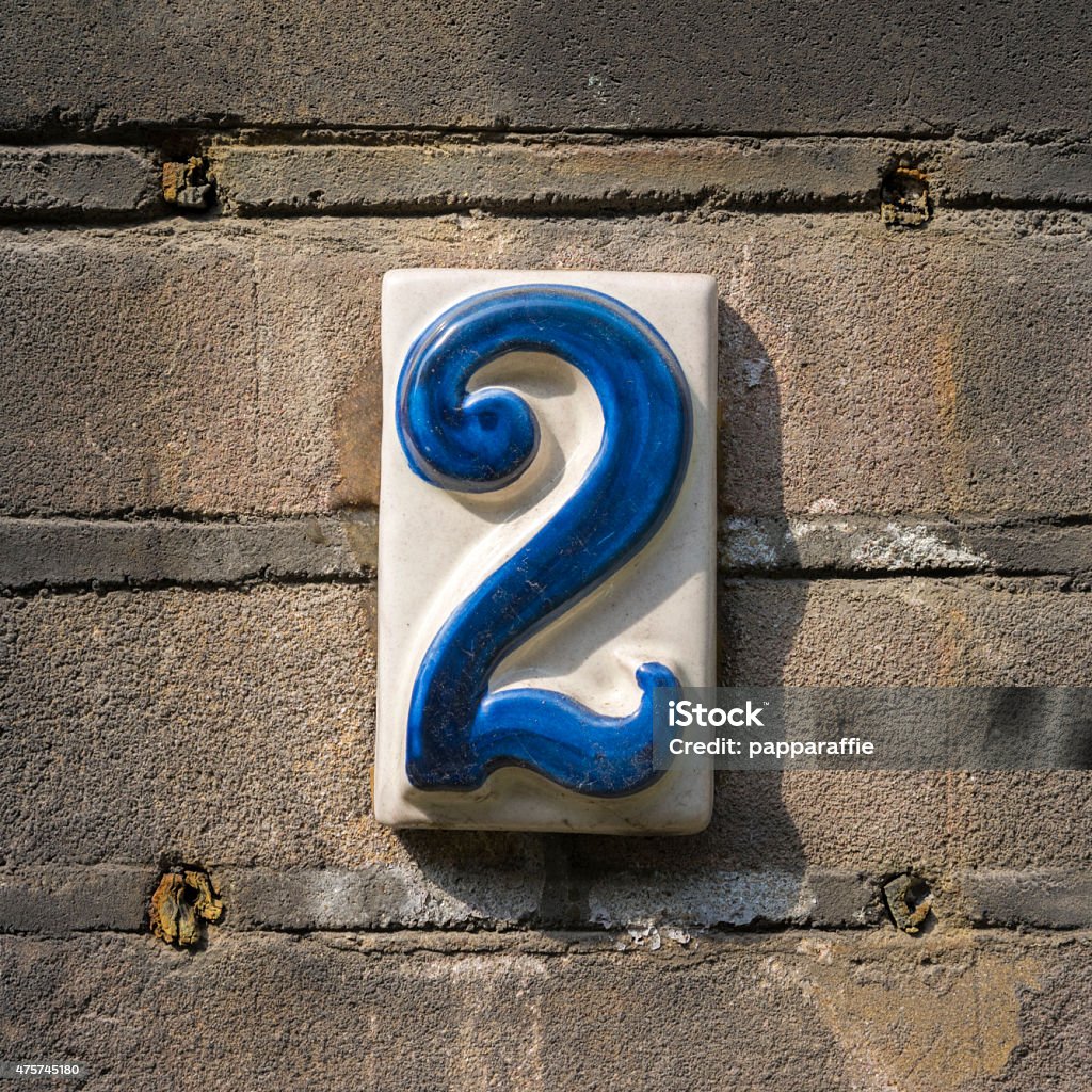 House number 2 ceramic house number two on a brick wall. Number 2 Stock Photo