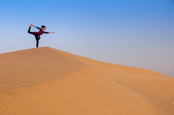 istock Young female practising yoga pose King Dancer or Natarajasana 475745238