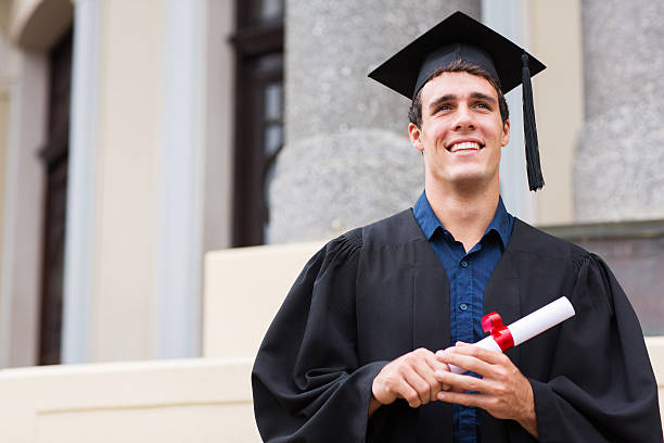 istock male graduate outside college building 475745415