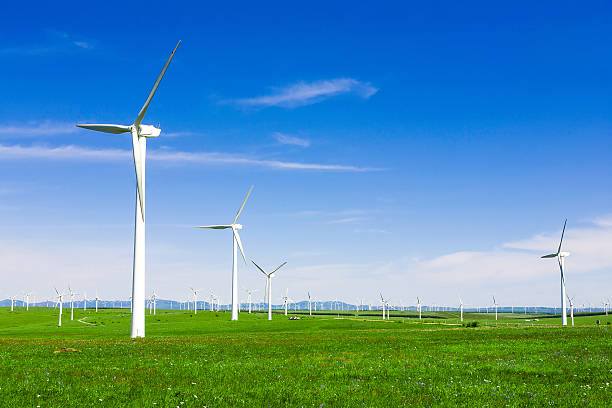 istock wind turbine and meadow under blue sky 475745422