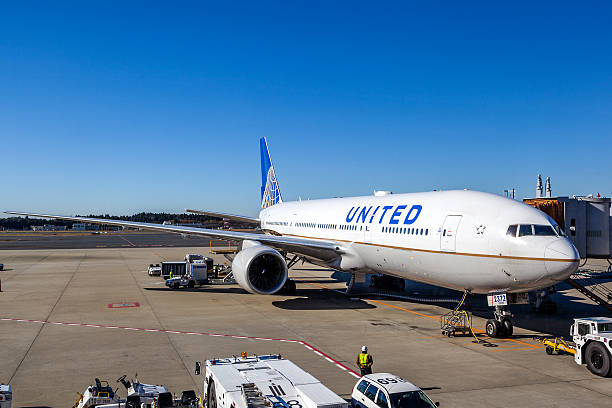 United Airlines on the Tarmac of Narita Airport Tokyo, Japan - December 5, 2014: A United Airlines plane being serviced on the tarmac of Narita Airport. After its merger with Continental in 2010, United has become the world's largest airline. narita japan stock pictures, royalty-free photos & images