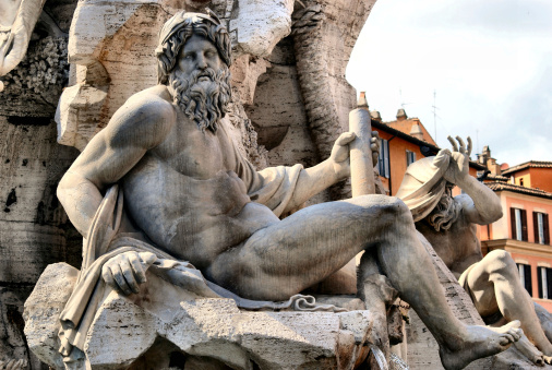 Statue of the god Zeus in a fountain (Fontana Dei Quattro Fiumi) in Piazza Navona (Rome - Italy)