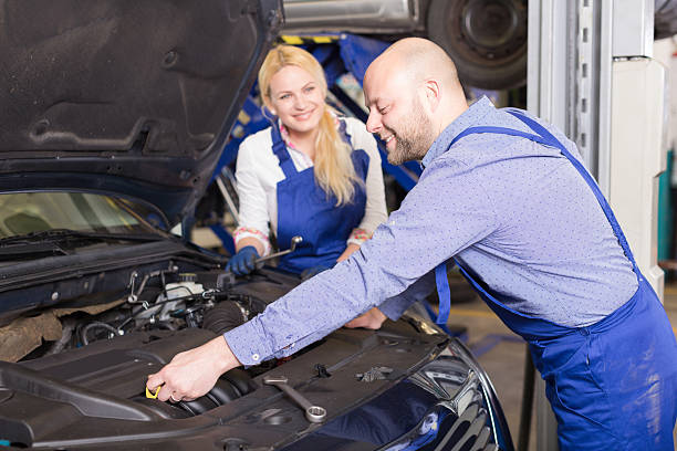 istock mechanic and assistant working at auto repair shop 475748748
