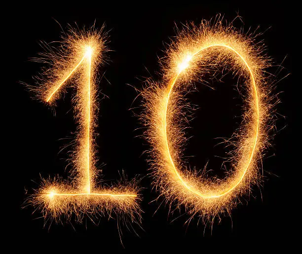 "10" number drawn with bengali sparkles isolated on black background
