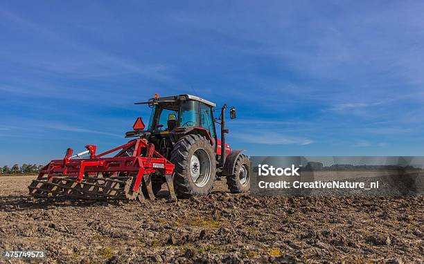 Tractor With Plough At Work Stock Photo - Download Image Now - Tractor, Plowing, Plow