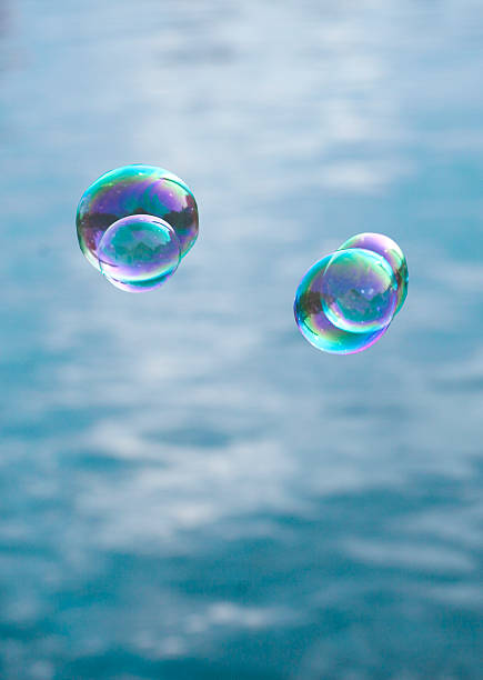 istock soap bubble flying over lake water 475750434