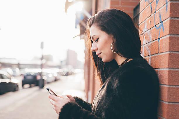 istock young beautiful woman using smartphone 475750468