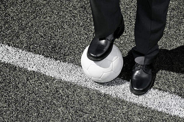 istock Coach with Soccer Ball on the Touchline 475750888