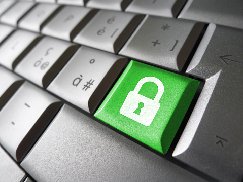 Internet, web and computer data security concept with padlock icon and symbol on a green laptop key for website and online business.