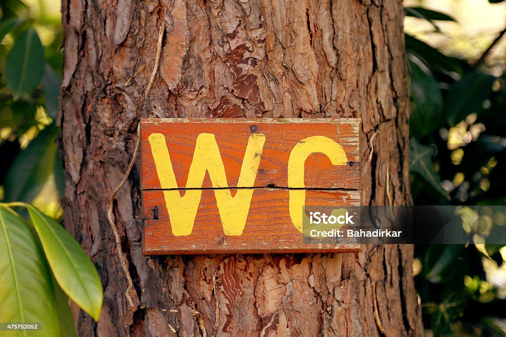 wc sign on tree wc sign Urinating Stock Photo