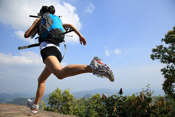istock young asian woman hiker running on mountain peak cliff 475752292