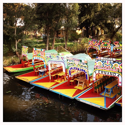 Xochimilco, Mexico - December 30, 2014: Parked Trajinera boats, which hold up to 20 people and have a meal, drink and music on board.