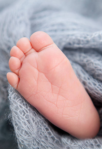 istock tiny foot of newborn baby 475753254