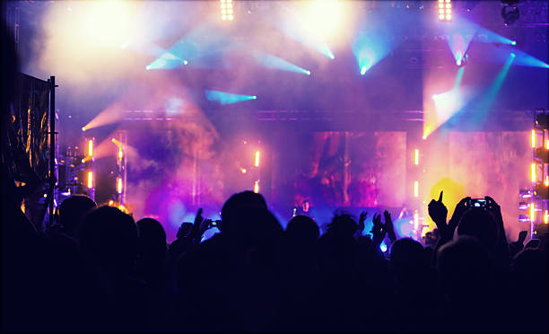 istock Cheering crowd in front of stage lights - retro photo 475753362