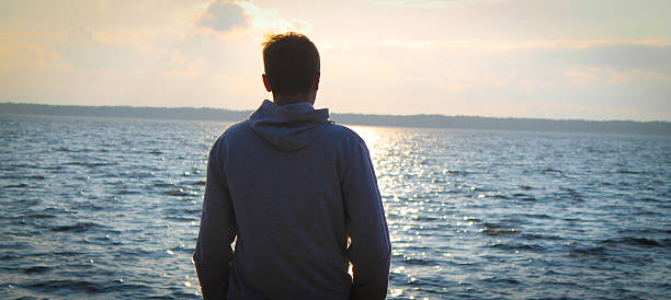 istock Man stand by the water 475753967