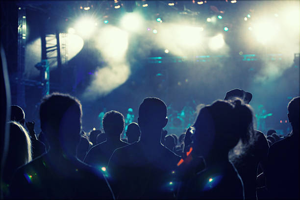 istock Cheering crowd in front of stage lights - retro photo 475755984