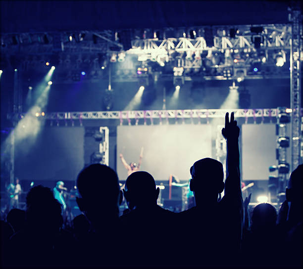 istock Cheering crowd in front of stage lights - retro photo 475755998