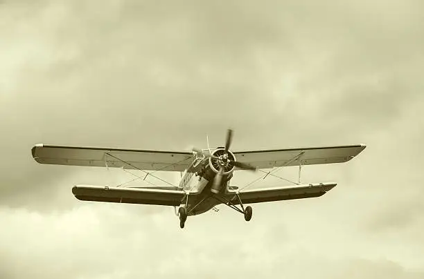 Old retro plane flies in the sky.