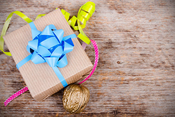 istock Christmas gift on wooden background 475757186