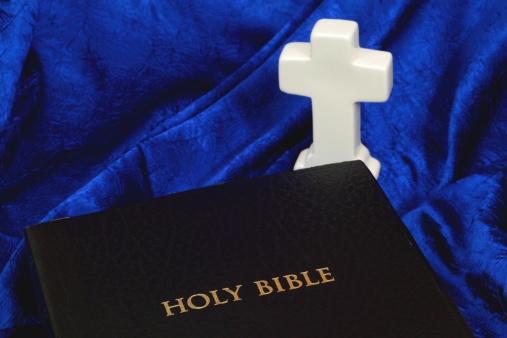 Black Holy Bible with white Cross.