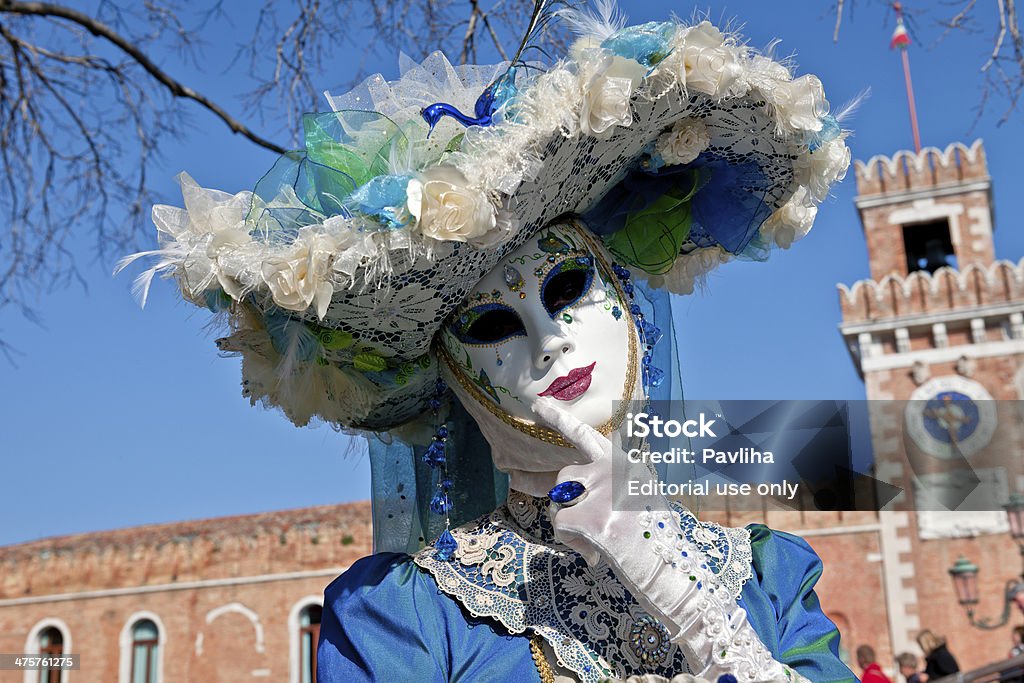 Venice Carnival VI Venice, Veneto, Italy - February 24th, 2014: Beautiful blue and white mask, participant of the 2014 Carnival celebrations, posing for casual photographers and tourists at Arsenale. Adult Stock Photo