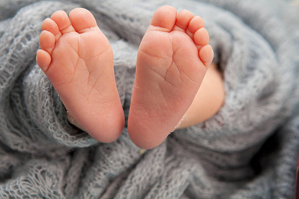 istock tiny foot of newborn baby 475762814