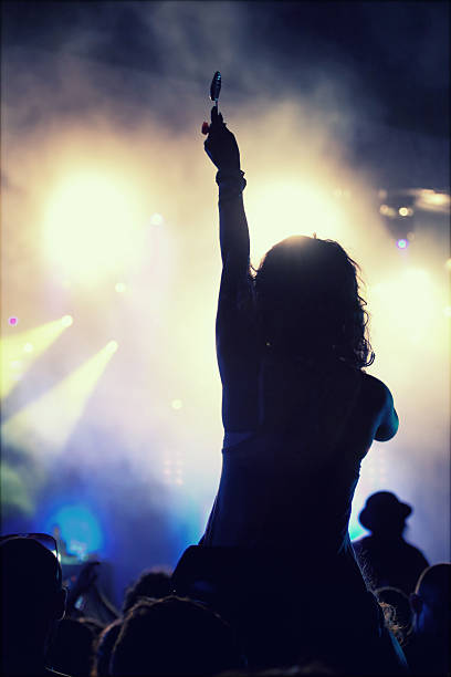istock Cheering crowd in front of stage lights - retro photo 475763286