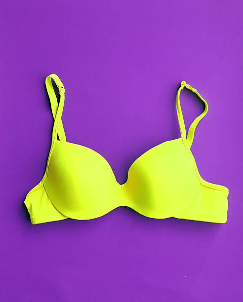 istock Yellow Cotton Bra on violet background 475766222