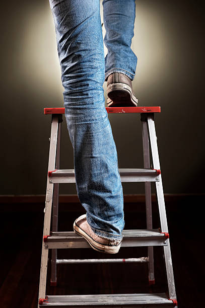 Man on ladder stock photo