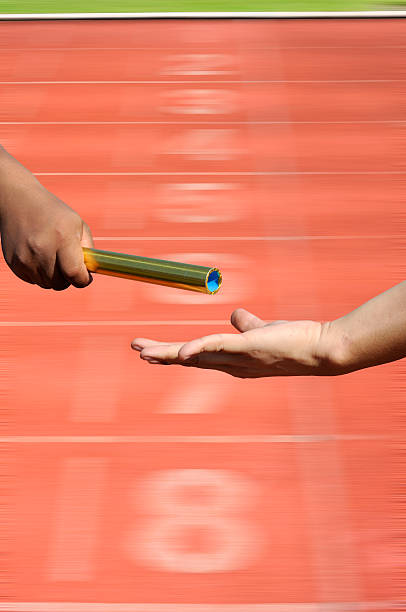istock Relay-athletes hands sending action on blur race track  startin 475767156