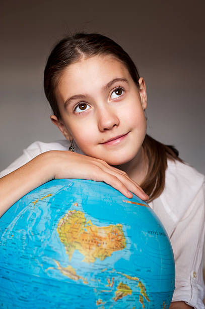 istock Dreaming girl with blue globe 475767653