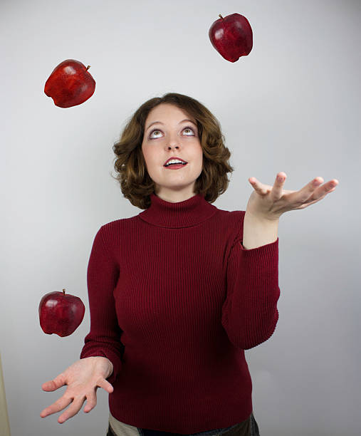 istock Woman juggling apples 475770147