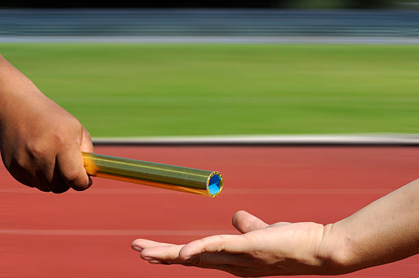 istock Relay-athletes hands sending action on blur race track, sport a 475770520